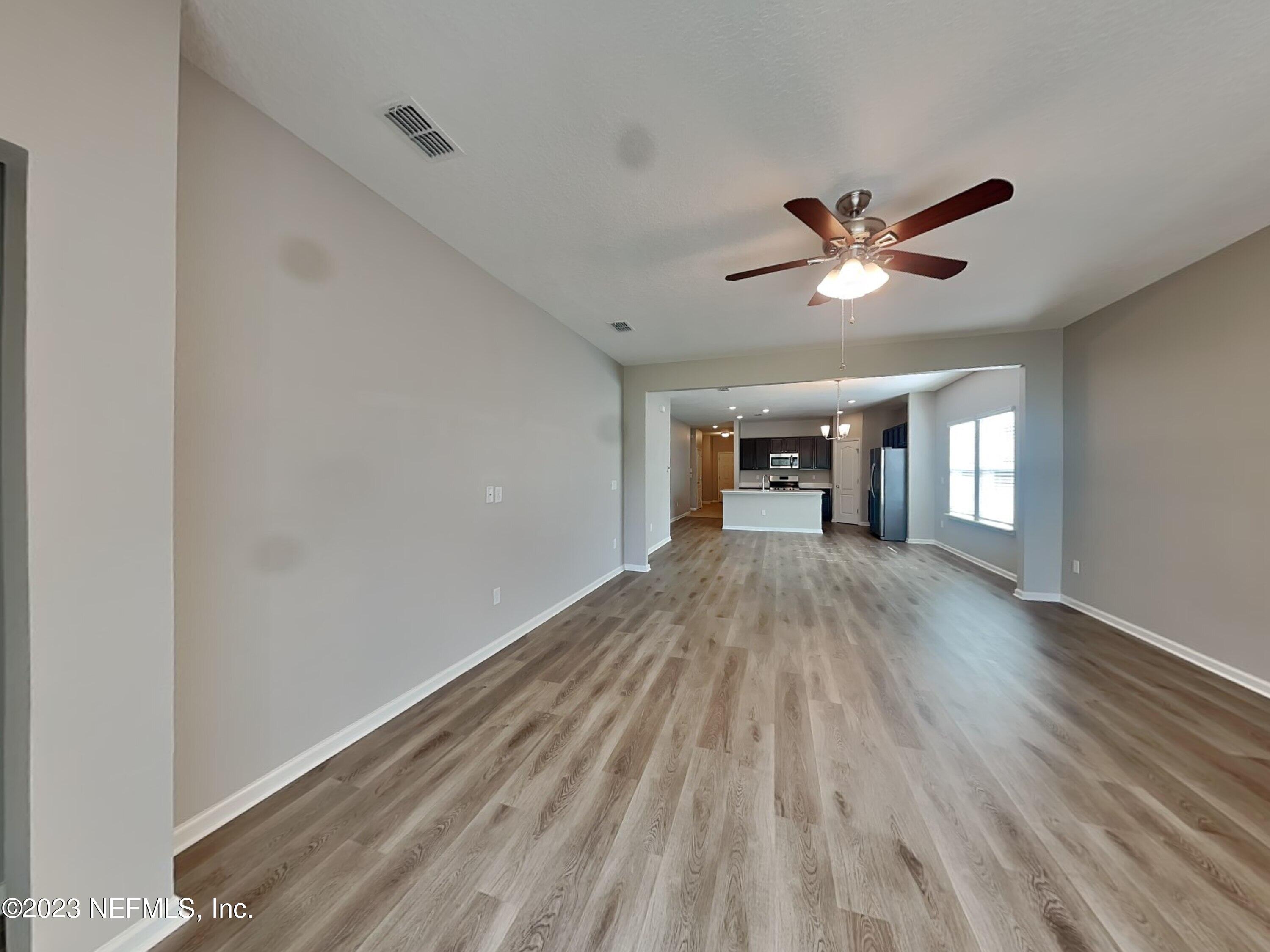 164 Bloomfield Way St. Augustine, FL 32092 - Photo 3 of 21 a view of empty room with wooden floor and ceiling fan