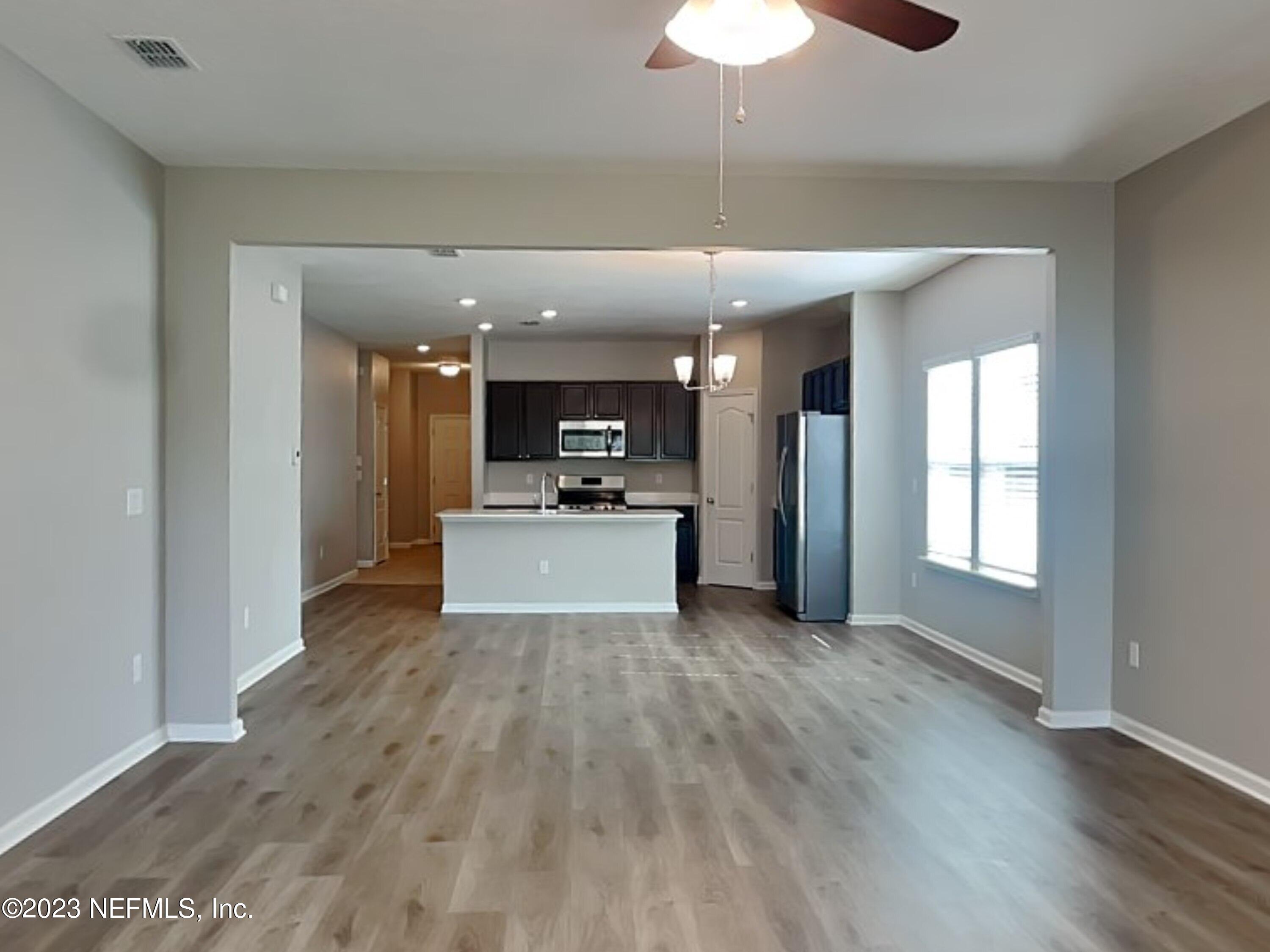 164 Bloomfield Way St. Augustine, FL 32092 - Photo 4 of 21 a view of a big room with wooden floor and a kitchen