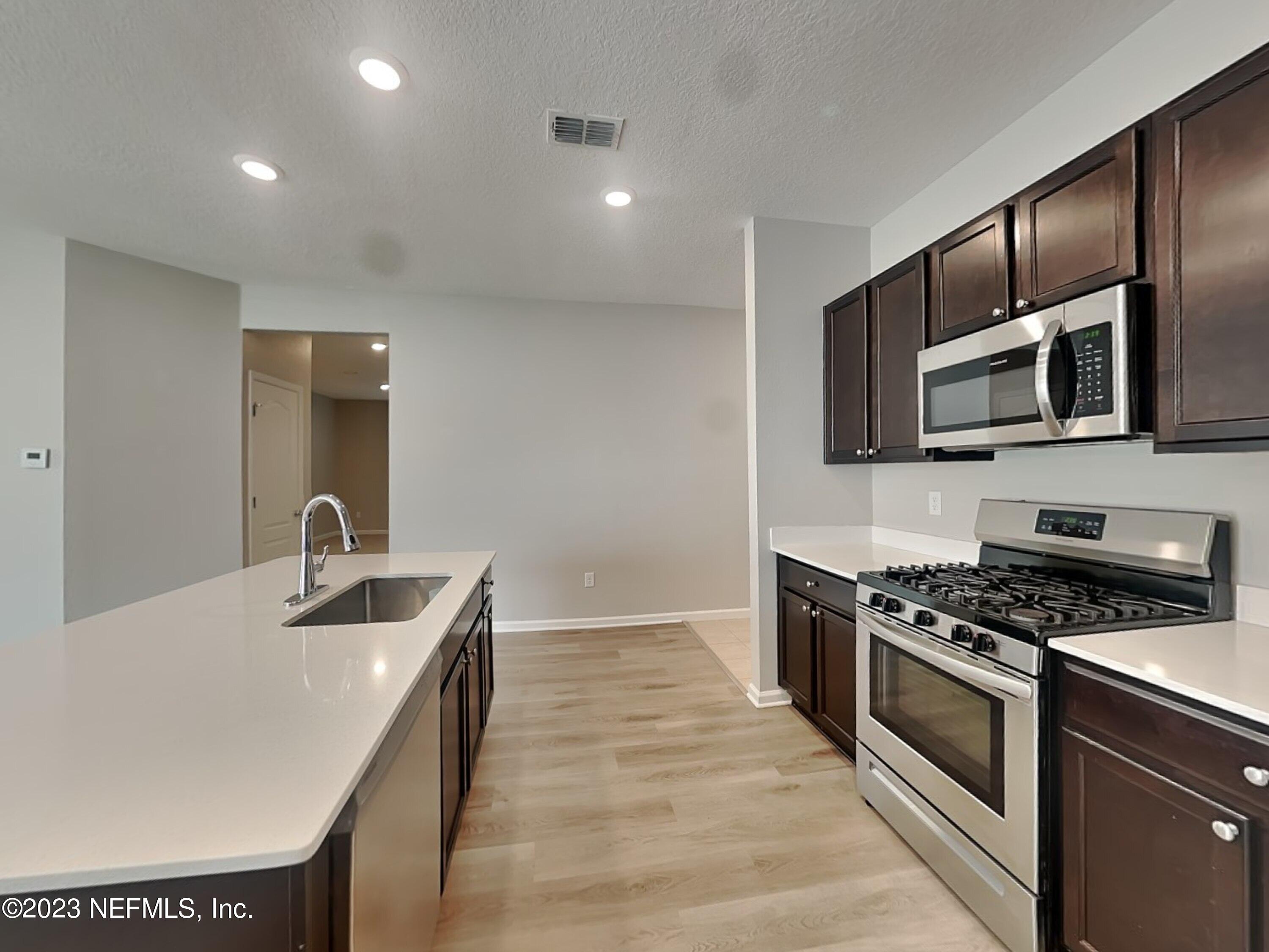 164 Bloomfield Way St. Augustine, FL 32092 - Photo 5 of 21 a kitchen with granite countertop a sink and steel appliances