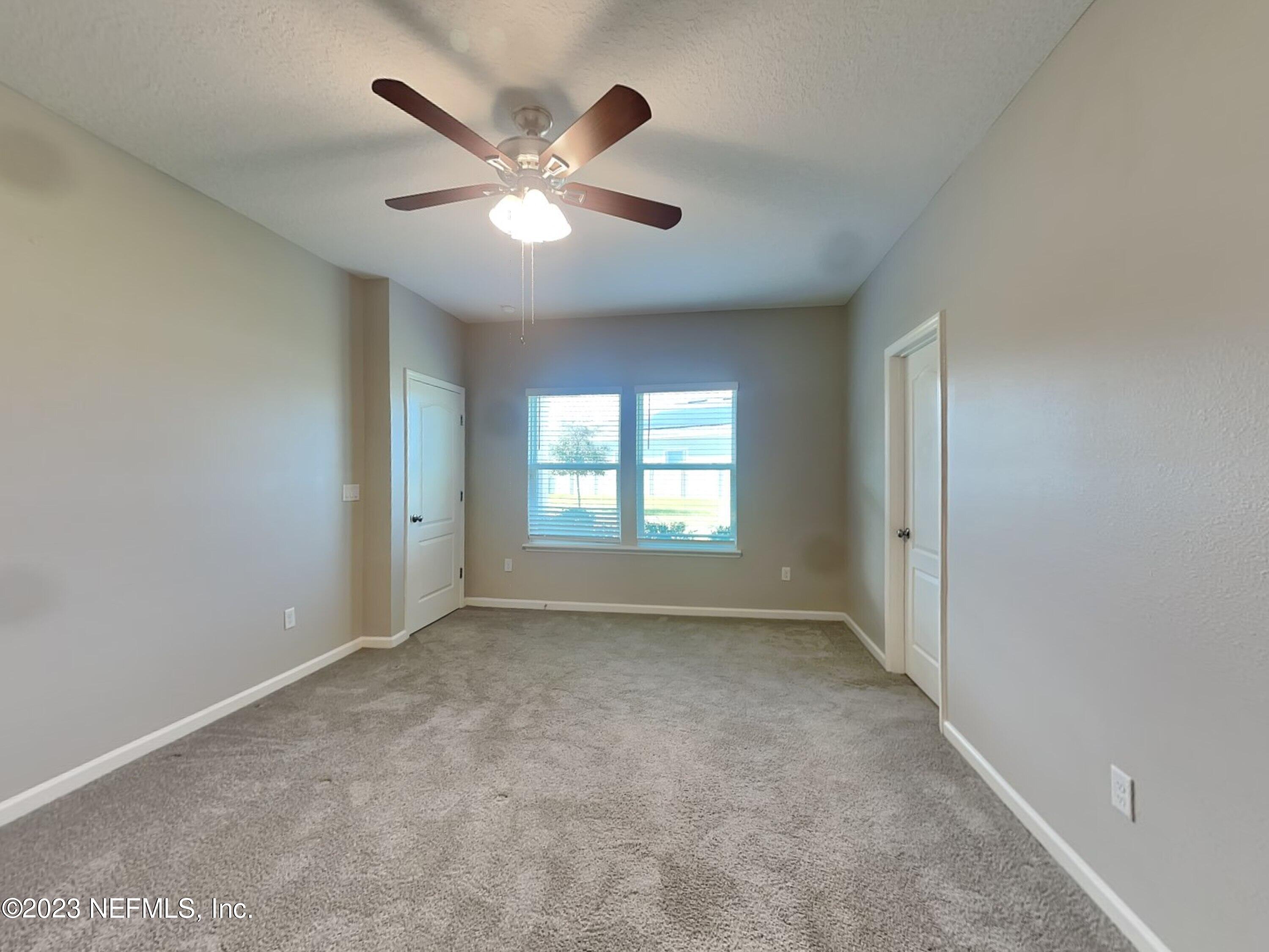 164 Bloomfield Way St. Augustine, FL 32092 - Photo 8 of 21 an empty room with windows and fan