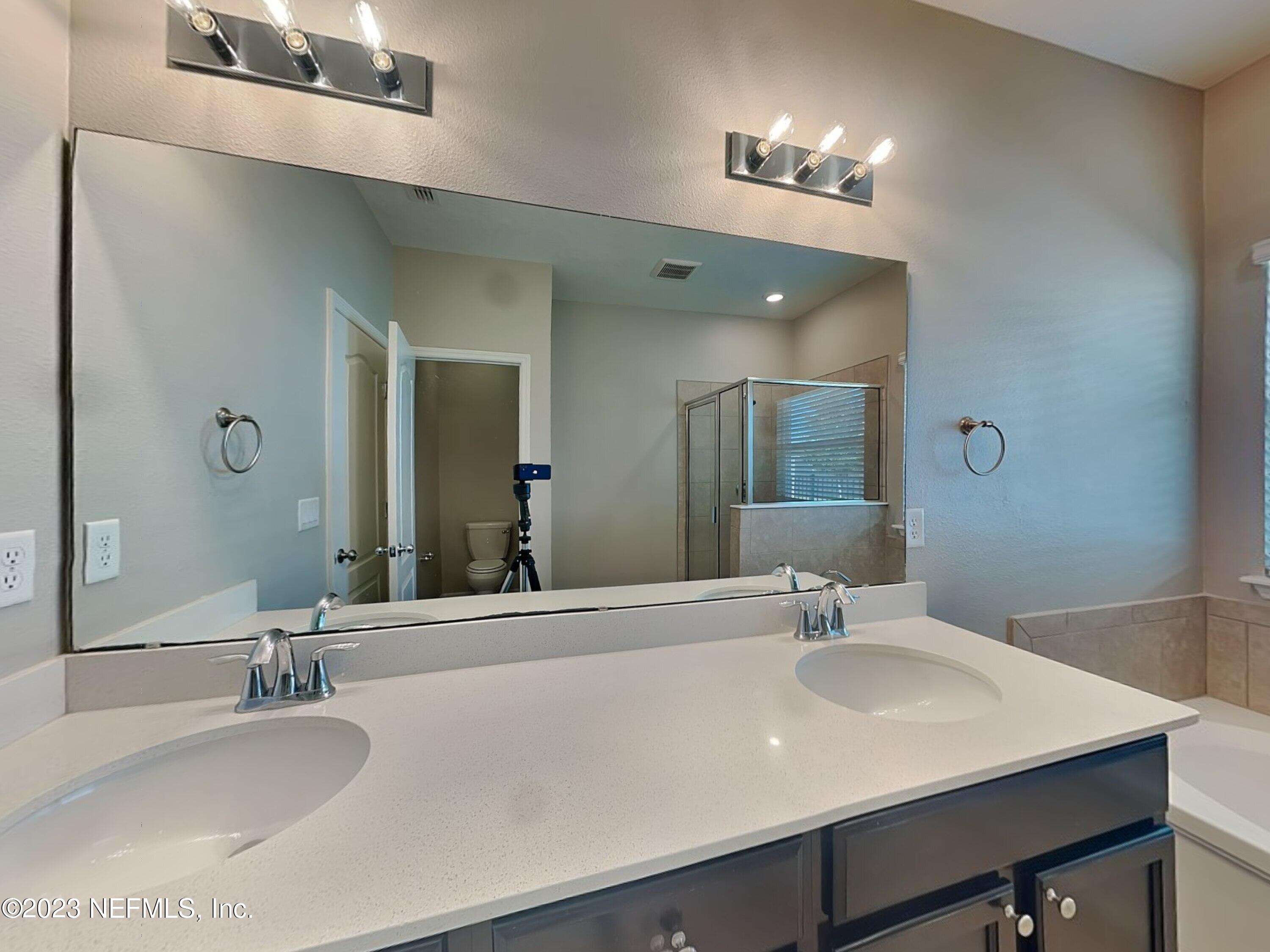 164 Bloomfield Way St. Augustine, FL 32092 - Photo 9 of 21 a bathroom with a sink and a mirror