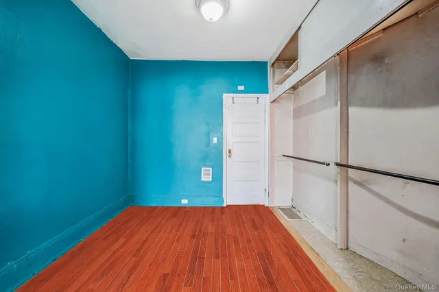 a view of a room with wooden floor