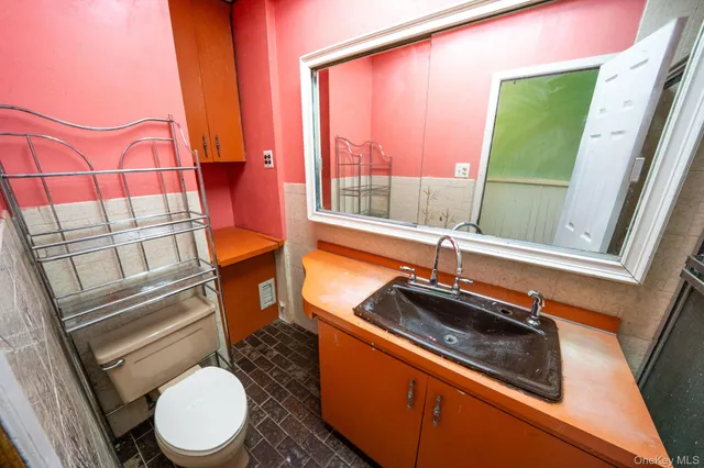 a bathroom with a sink a toilet and tub