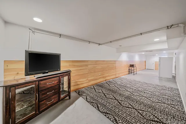 a bedroom with a bed and flat screen tv