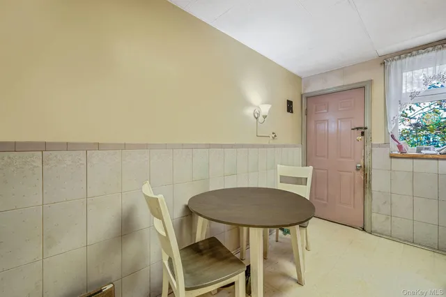 a view of a room with a table and chairs