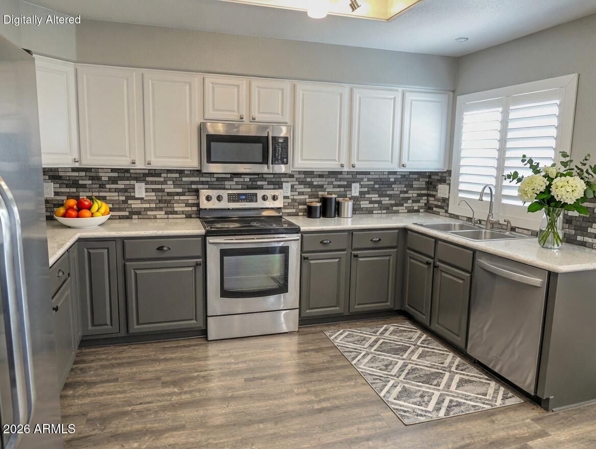 4409 East Dry Creek Road Phoenix, AZ 85044 - Photo 5 of 34 a kitchen with stainless steel appliances granite countertop a sink and cabinets