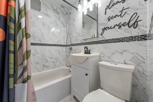 an empty room with windows and fireplace