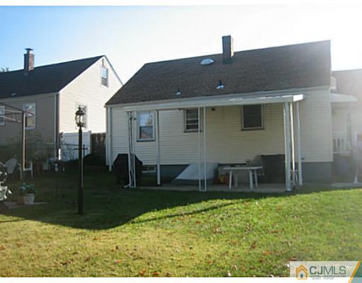 26 Dover Road Colonia, NJ 07067 - Photo 2 of 13 a backyard of a house with table and chairs
