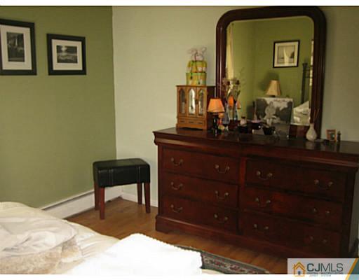 26 Dover Road Colonia, NJ 07067 - Photo 8 of 13 a room with a dresser and mirror
