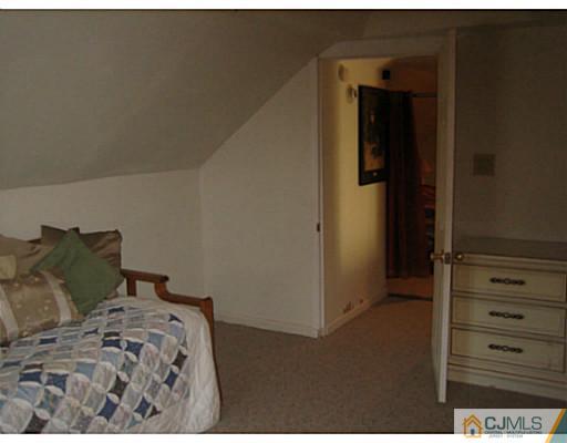 26 Dover Road Colonia, NJ 07067 - Photo 10 of 13 a bedroom with a bed and a dresser