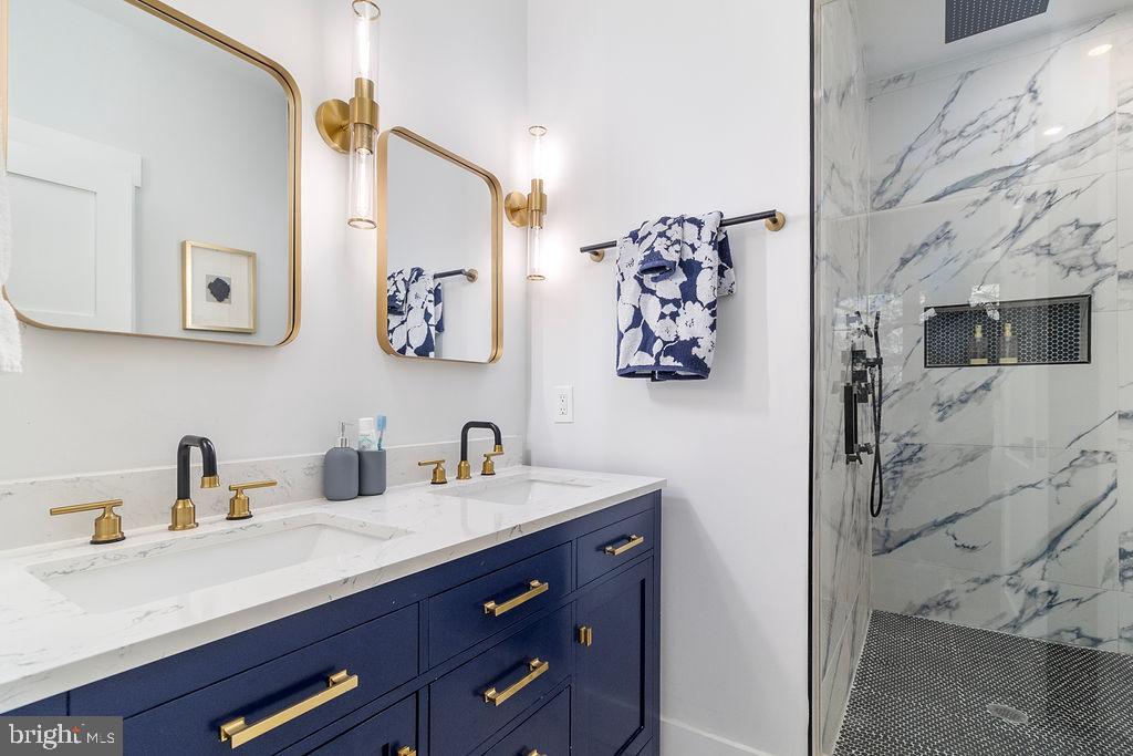 1242 Meigs Place Northeast, Unit 3 Washington, DC 20002 - Photo 11 of 13 a bathroom with a sink and a mirror