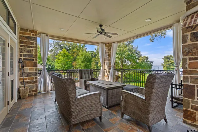 a view of a porch with furniture and a backyard