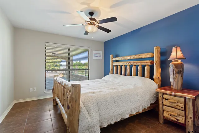 a bedroom with a bed next to a window