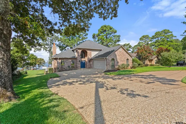 a front view of a house with a yard and a garage