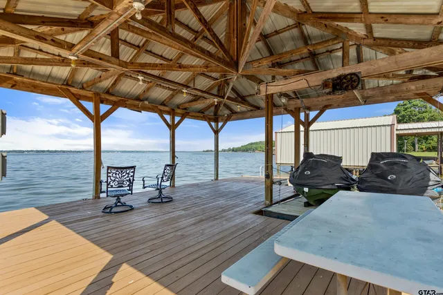 a view of a balcony with chairs and wooden floor