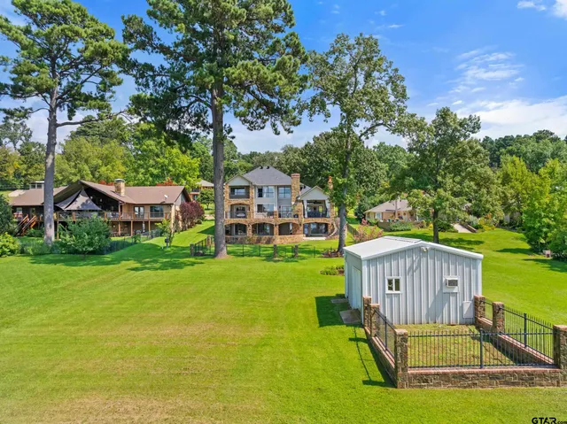 a view of a house with a yard deck and a slide