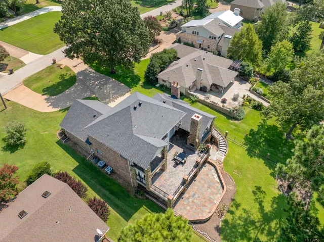 an aerial view of a house with garden space and street view