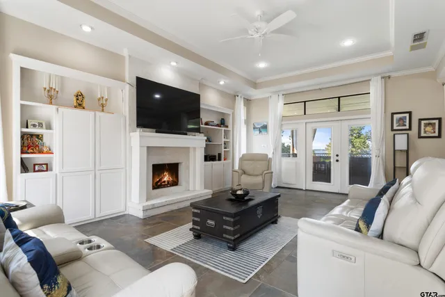 a living room with furniture a flat screen tv and a fireplace