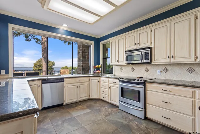 a kitchen with appliances cabinets and a sink