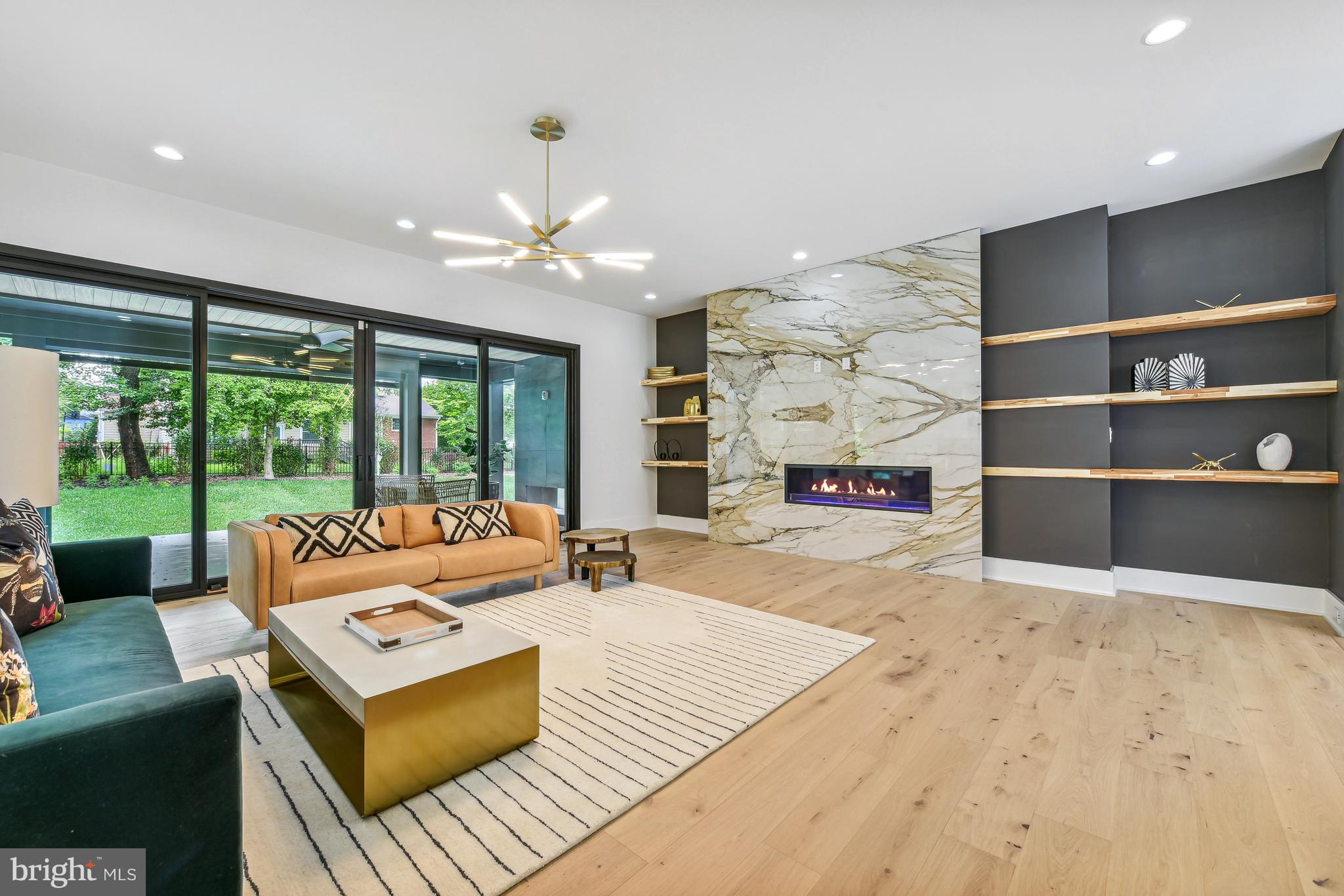 7102 Capitol View Drive McLean, VA 22101 - Photo 11 of 40 a living room with furniture fireplace and large windows