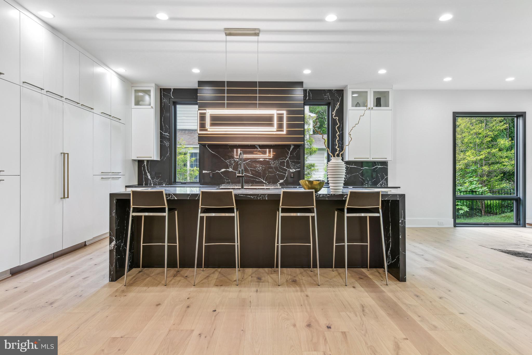 7102 Capitol View Drive McLean, VA 22101 - Photo 13 of 40 a kitchen with stainless steel appliances kitchen island granite countertop a table chairs sink and cabinets