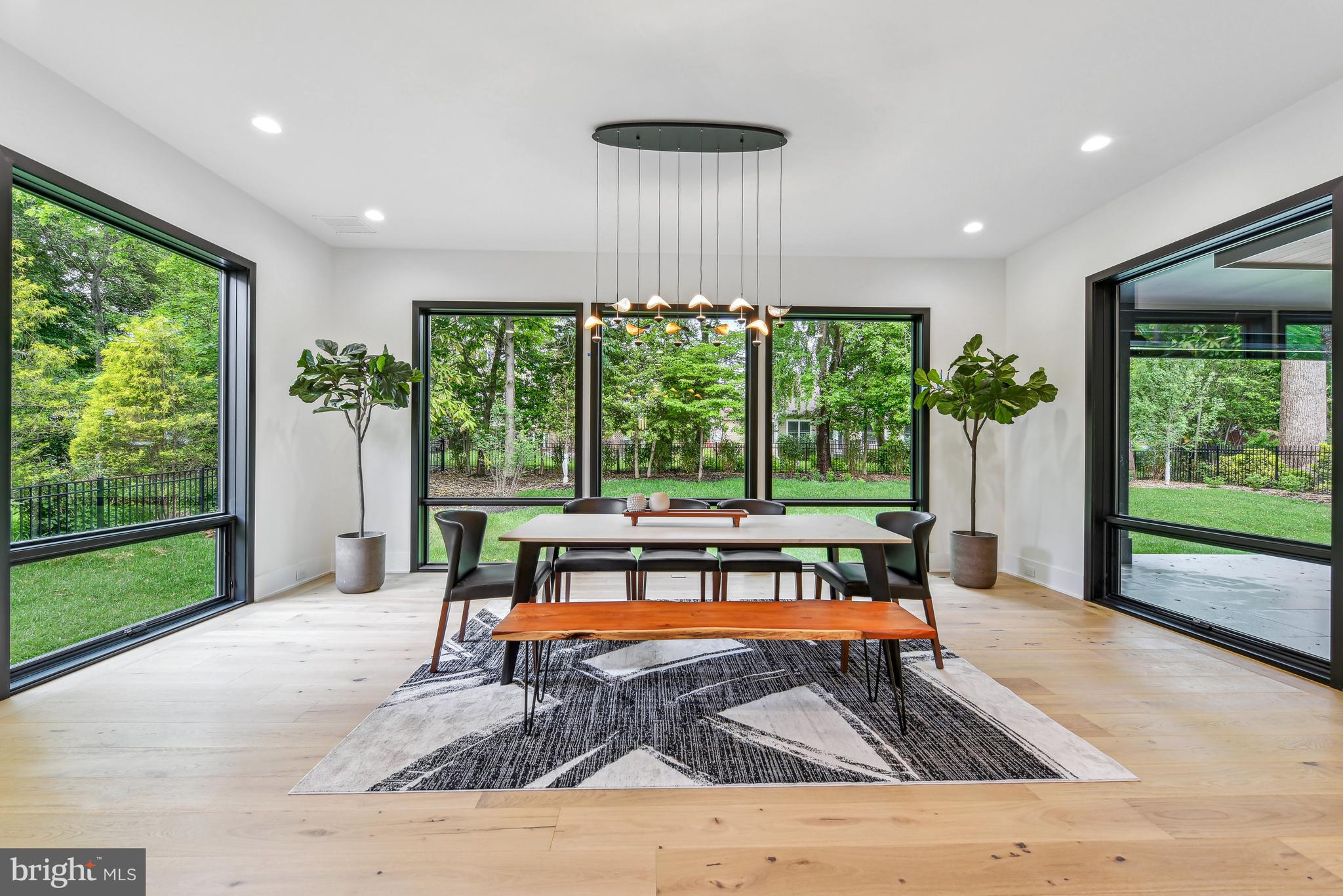7102 Capitol View Drive McLean, VA 22101 - Photo 16 of 40 a living room with a fireplace and large windows