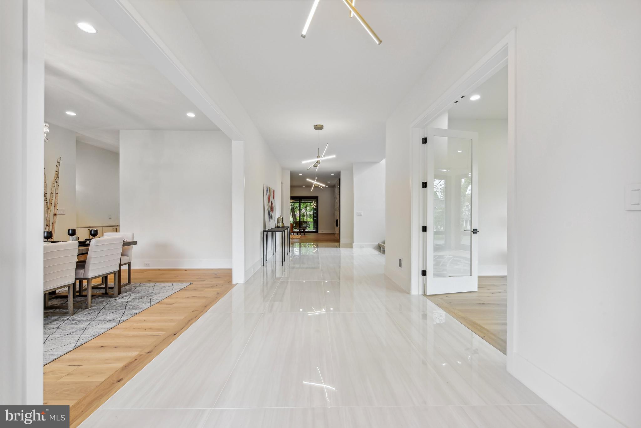 7102 Capitol View Drive McLean, VA 22101 - Photo 4 of 40 a view of a hallway with wooden floor a fireplace and windows