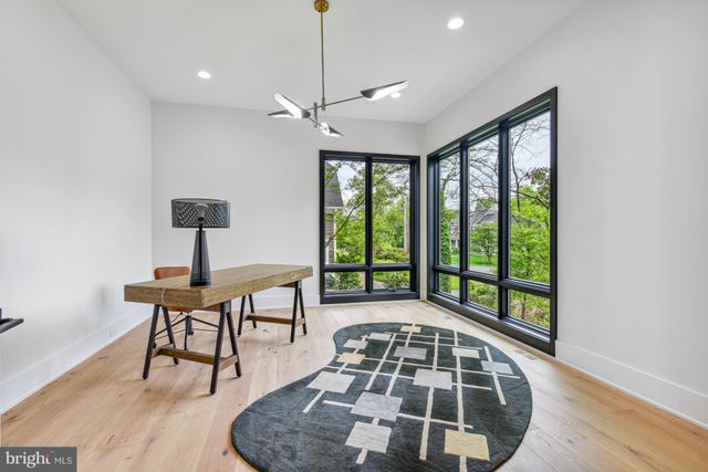 a spacious bathroom with a sink a toilet and a mirror