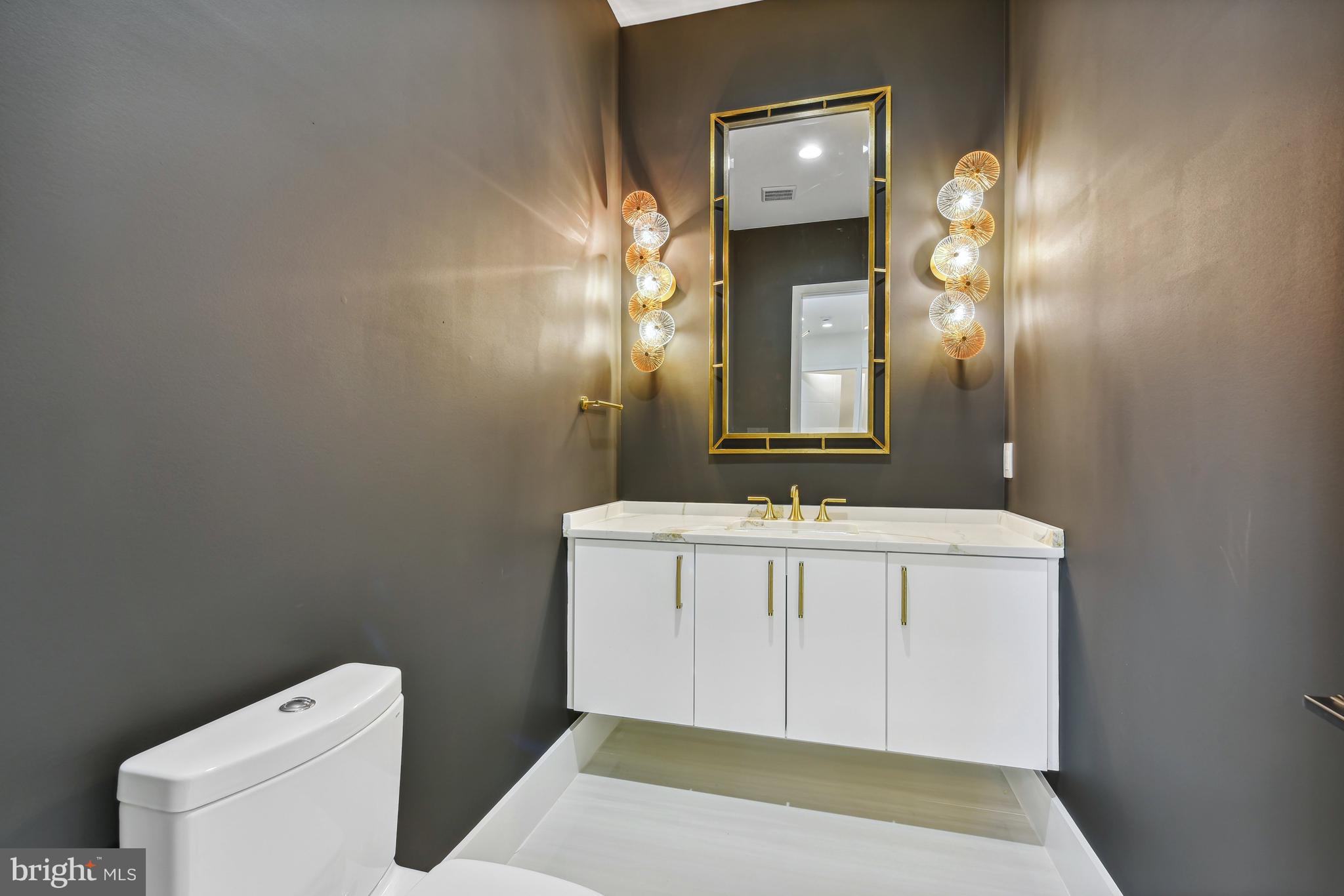 7102 Capitol View Drive McLean, VA 22101 - Photo 9 of 40 a spacious bathroom with a sink a toilet and a mirror