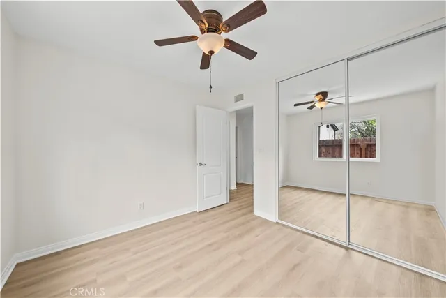 a view of an empty room with a ceiling fan