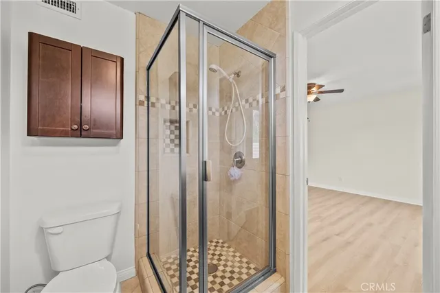 a bathroom with a shower and a toilet