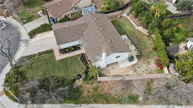 an aerial view of a house with a yard