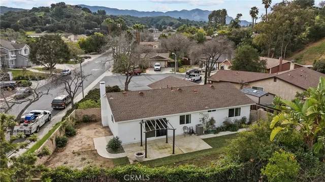 an aerial view of multiple houses with a yard