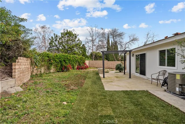 a view of a backyard with sitting area