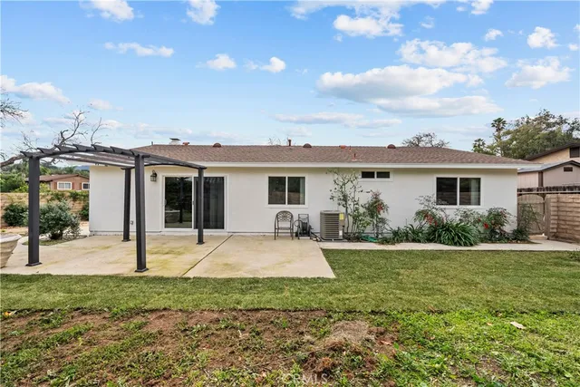 a front view of house with a garden and patio