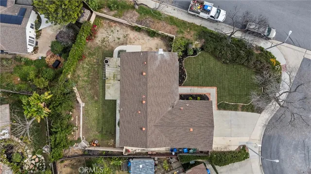 an aerial view of a house with a yard