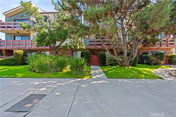 a view of house with outdoor space and trees