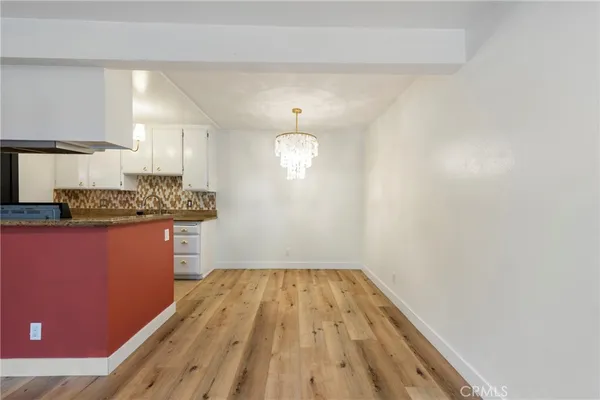a kitchen with a refrigerator and window