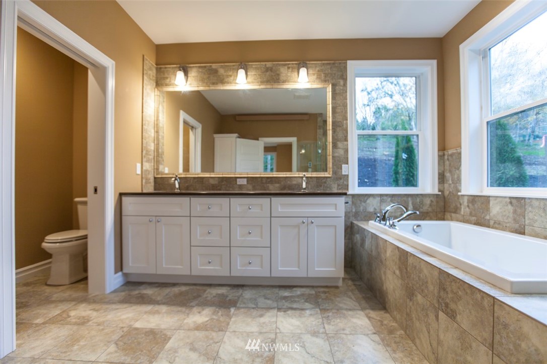 480 Whitecap Road Bellingham, WA 98229 - Photo 14 of 25 a spacious bathroom with a granite countertop tub sink and mirror