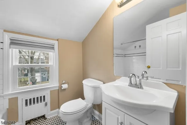 a bathroom with a sink toilet and a mirror