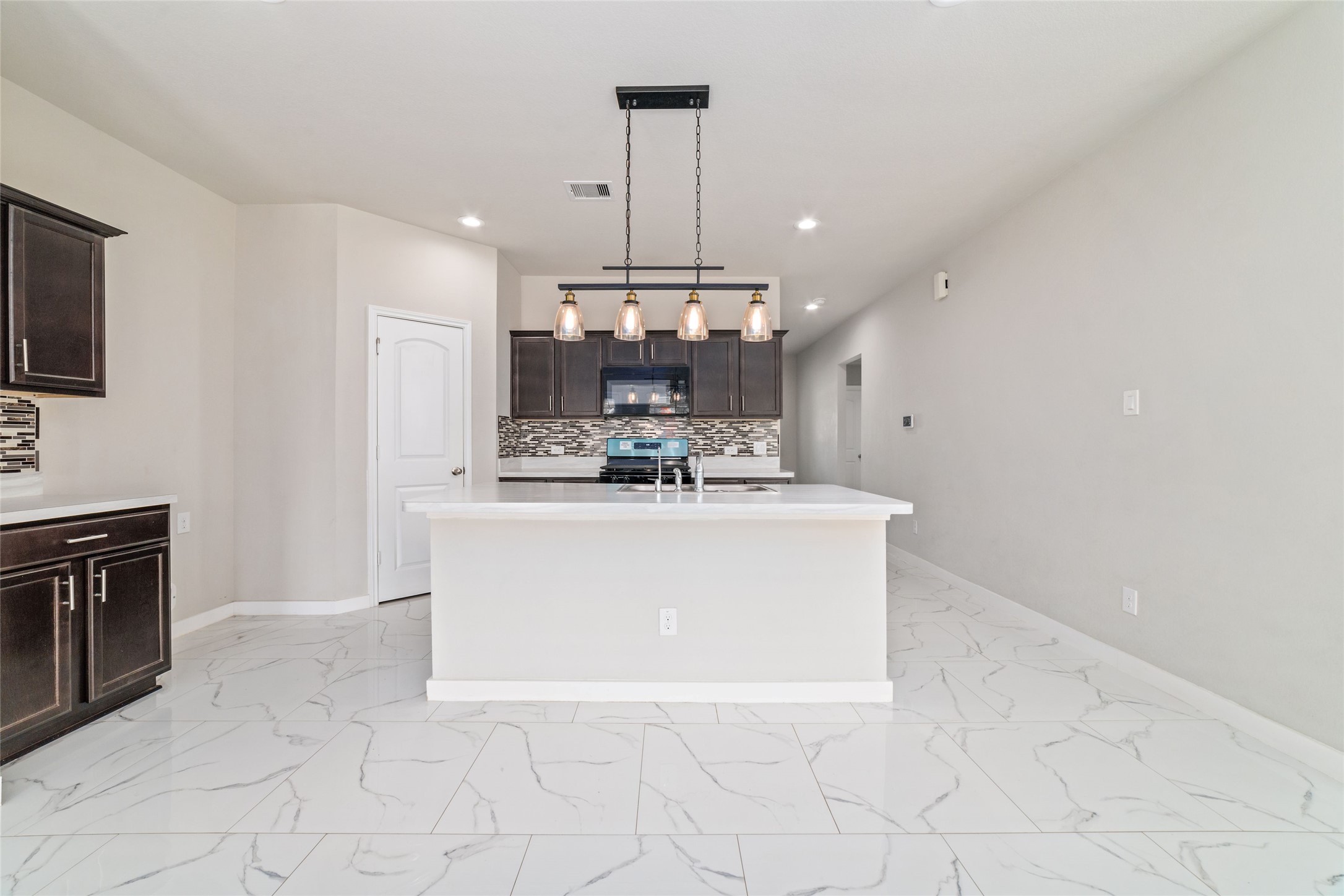 5502 Creekside Ridge Trail Katy, TX 77449 - Photo 14 of 25 a view living room with kitchen island granite countertop stainless steel appliances a stove a sink a refrigerator and a counter top space