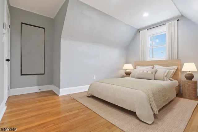 a bedroom with a bed and a night stand