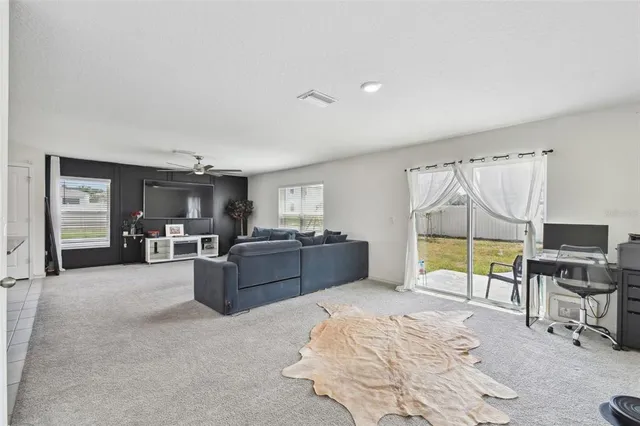 a bed room with furniture and a flat screen tv