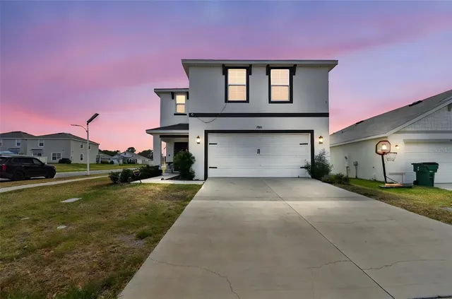 a front view of a house with a yard and garage
