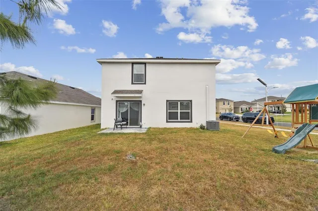 a view of a house with a yard and tree
