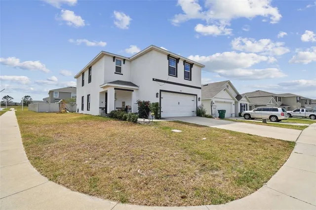 a view of a white house with a swimming pool