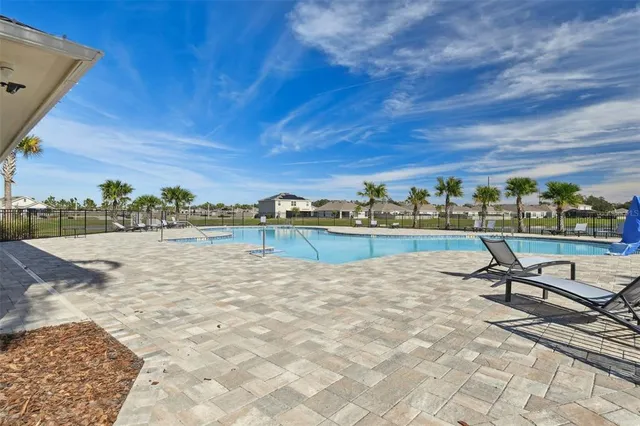 a view of a lake with a house and a yard