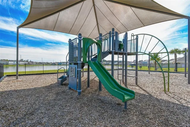 a view of an entryway with a floor to ceiling window and wooden floor
