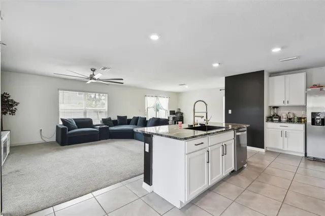 a kitchen with a sink stove and cabinets