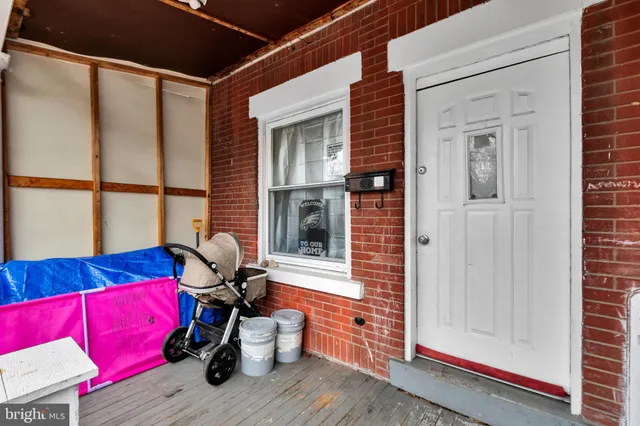a view of balcony with two chairs and a window